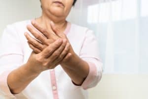 Older woman holding hand and wrist